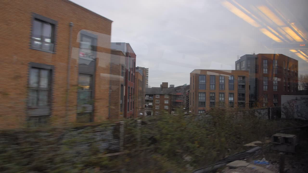Looking from the window of a commuter train. London UK. Depressing gray day.