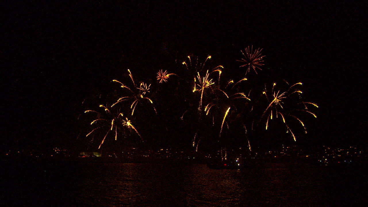fireworks at sea with cityscape background