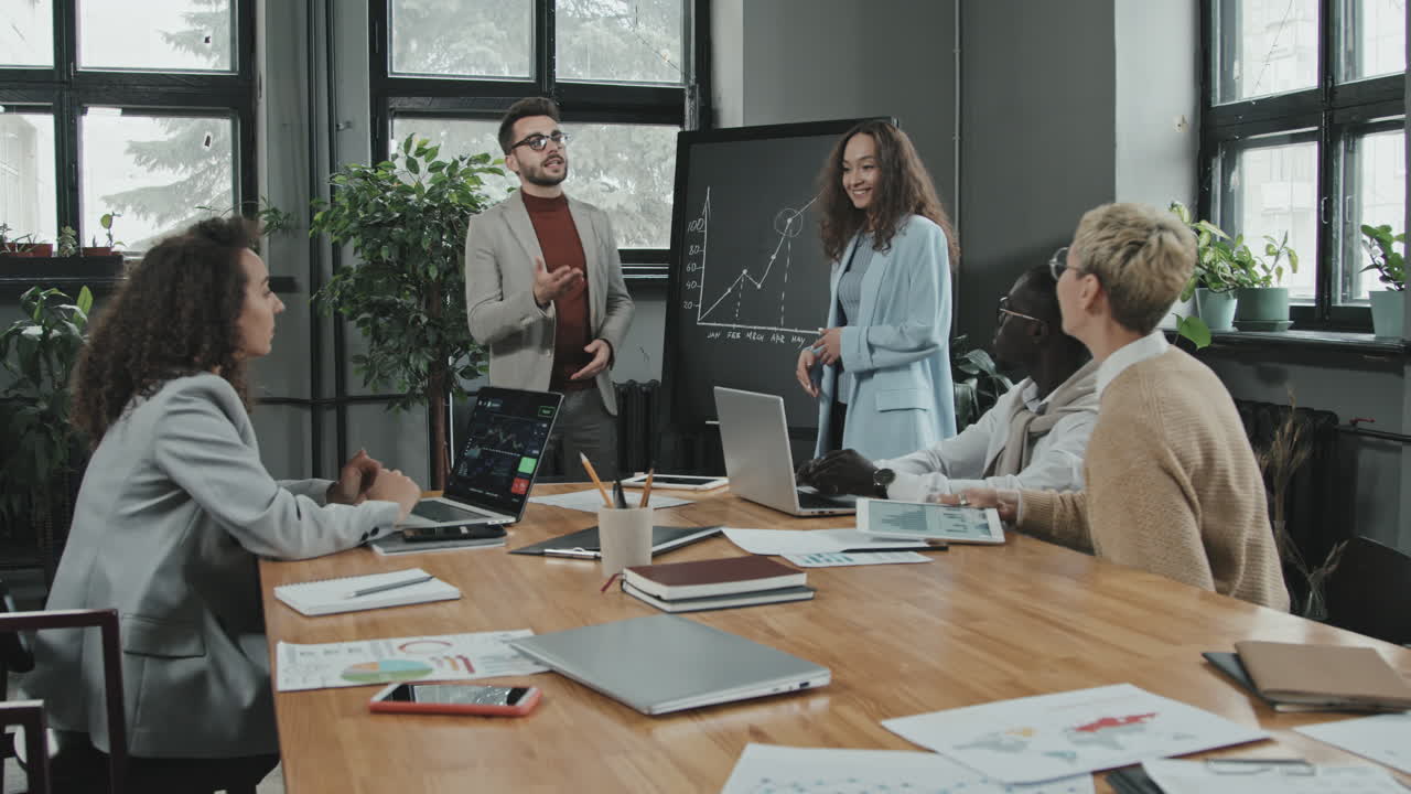 Coworkers Discussing Successful Results during Meeting