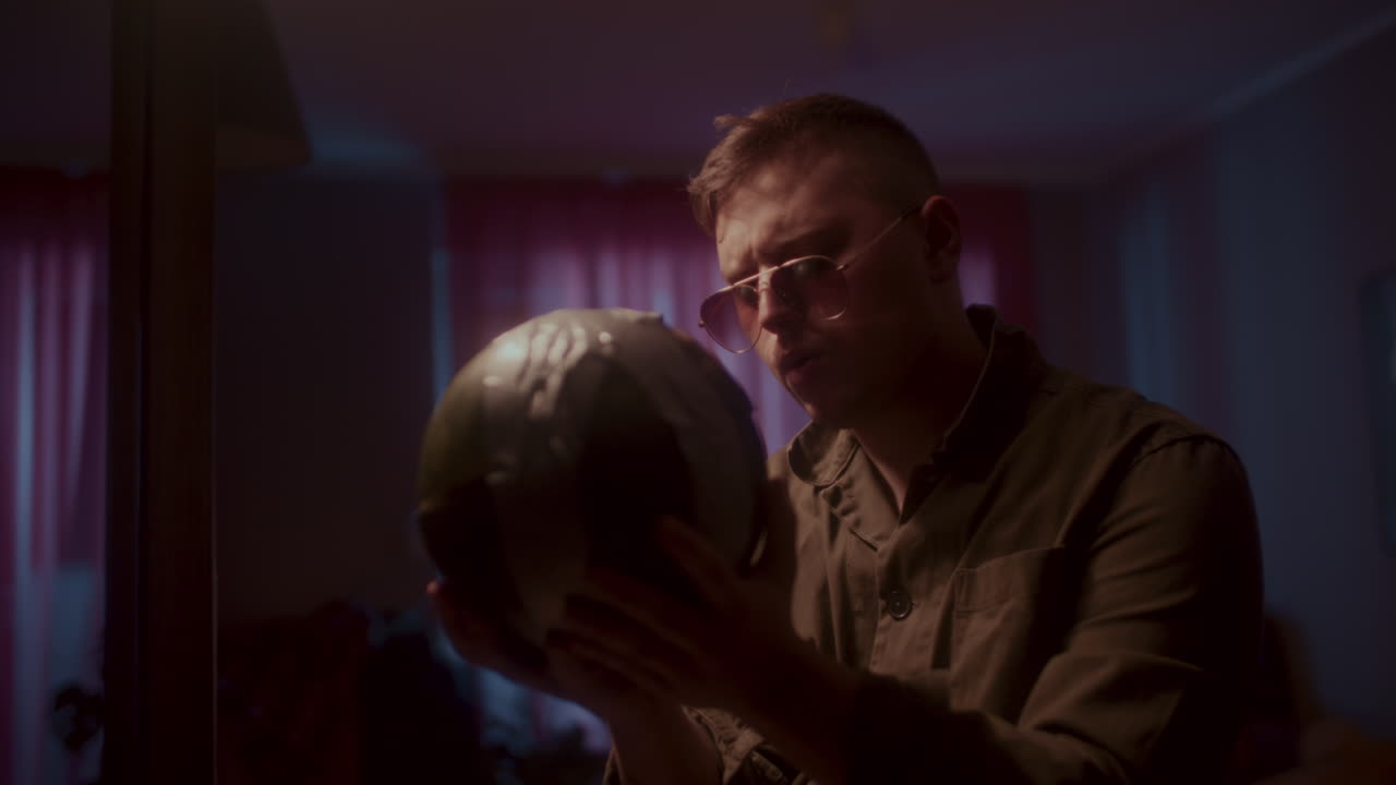 Man Holding a Ball in a Room