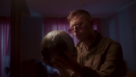 man holding a ball in a room