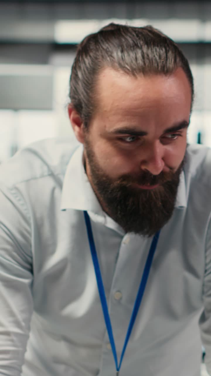 Vertical Video Diverse corporate team focuses on data management on computer