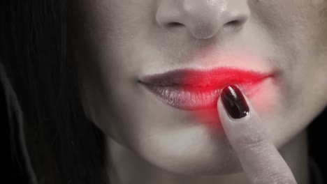 Close-up-view-of-a-woman-touching-her-lips