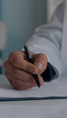 doctor filling out medical form