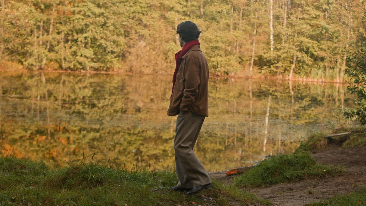 Man by a lake in autumn