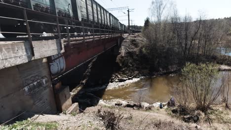 freight train crossing a bridge over a river