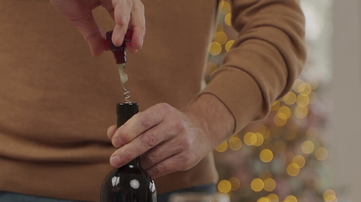 Uncorking A Bottle Of Wine For A Toast