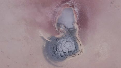 acidic mudpot with sulphur vapor coming from volcanic activity, aerial