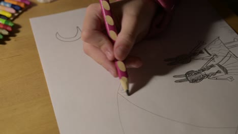 close up of skilled hands of girl child paint with pencil open paper art class concept