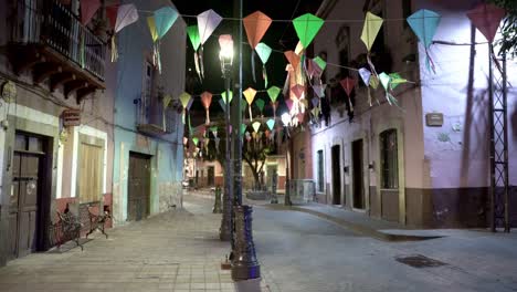 Colorful-kites-decorations-on-the-building-at-night-in-Guanajuato