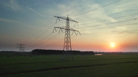 hydro tower - transmission towers at dusk by the polders. - aerial dolly shot