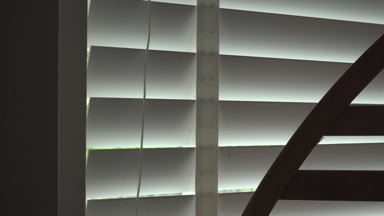 Closing the blinds shutters on a window