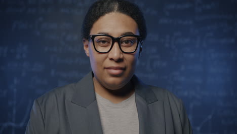 woman in front of chalkboard