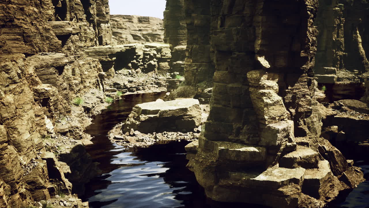 Canyon mirrors rugged rocks in tranquil midday waters