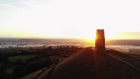 orbiting the misty sunrise over glastonbury tor and the somerset levels