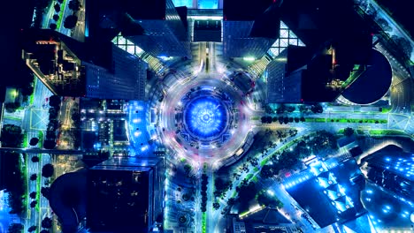 top view time lapse of the fountain and traffic in the circle at night at singapore