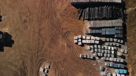 aerial top down view of a material and machinery storage yard near the highway construction site