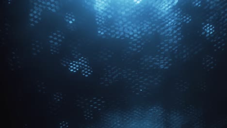 blue abstract optical blurred background. optical bokeh overlapped by moving honeycombs.