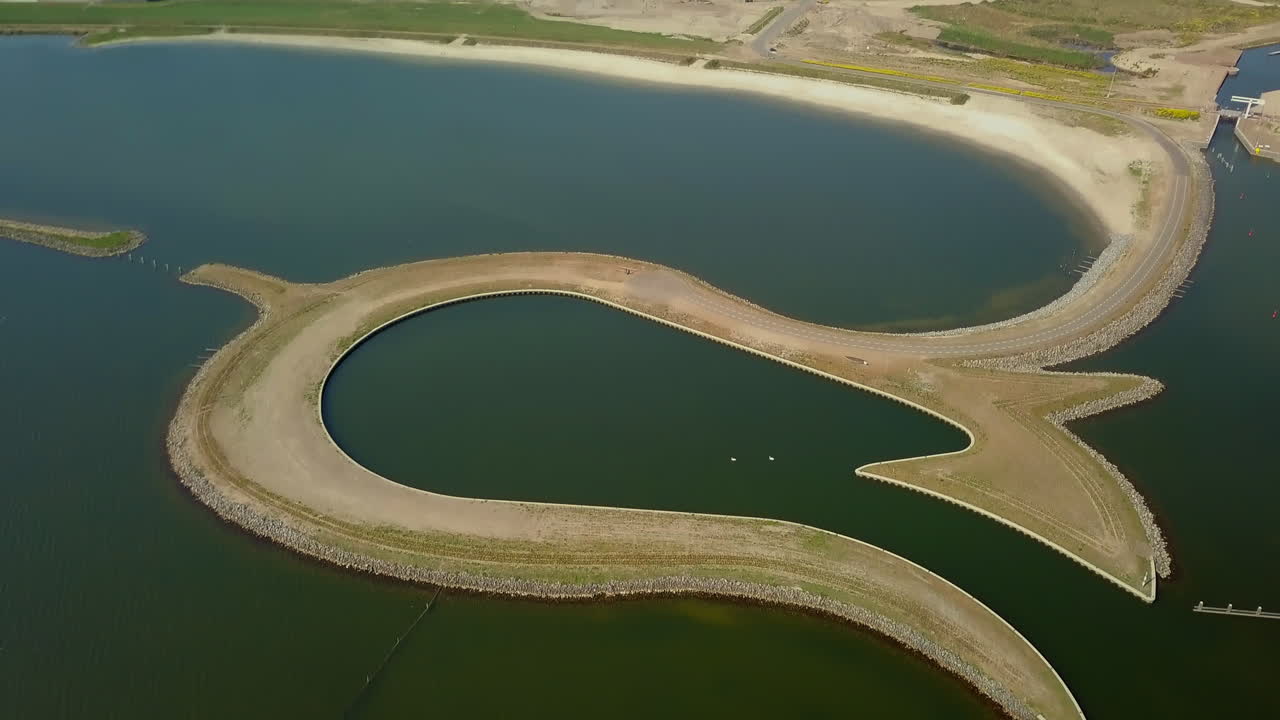 Aerial drone shot of tilting up over the manmade Tulip Island located at the coastline of the Zeewolde, Flevoland, the Netherlands.