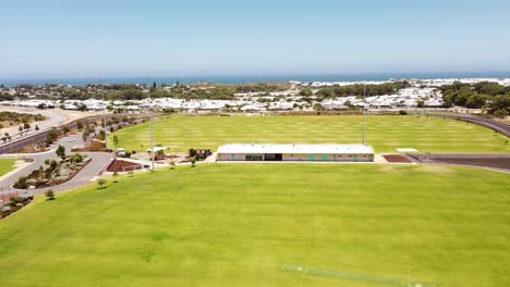 Yanchep-Splendid-Park-with-sports-facilities-and-perimeter-cycle-track,-Ocean-in-background