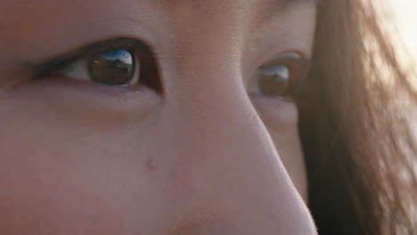 close-up-eyes-beautiful-asian-woman-contemplating-future-enjoying-mindfulness-relaxing-on-peaceful-beach-at-sunset