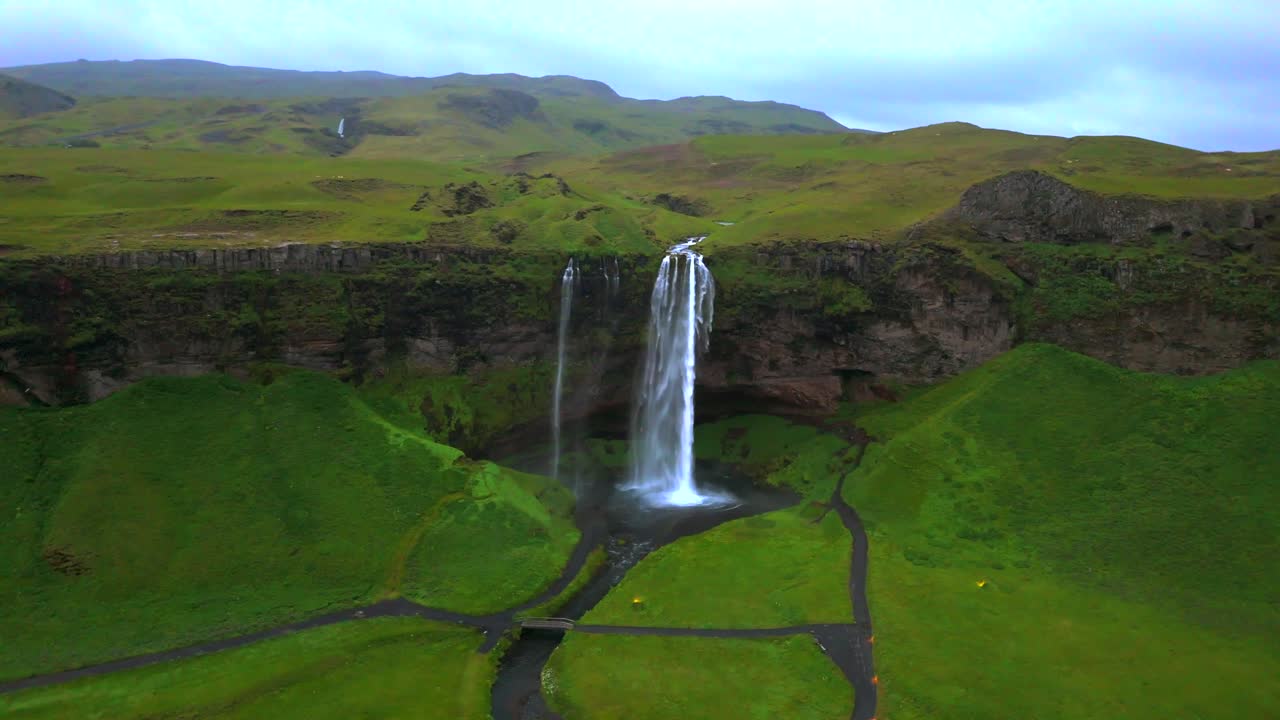 Journey through the skies above Seljalandsfoss, witnessing the waterfall’s stunning drop and the surrounding Icelandic wilderness.