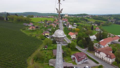 Orbiting-Around-Tall-Skinny-Building-in-Slovenska-Bistrica,-Slovenia