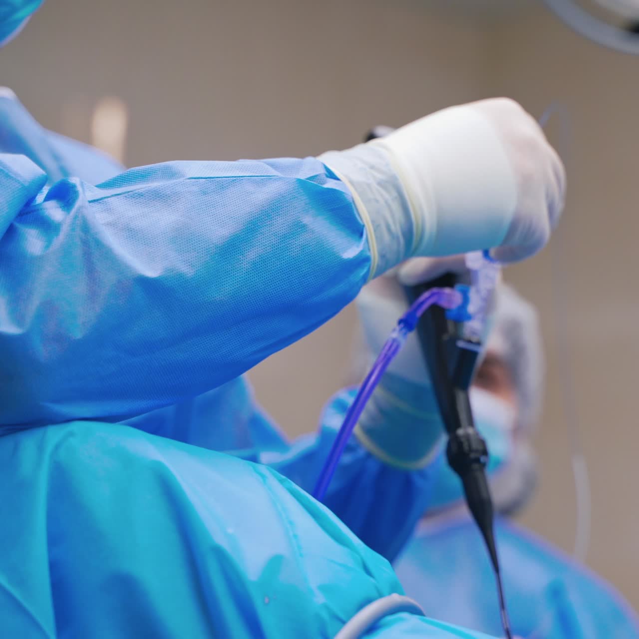 Group of doctors perform an operation to a patient. Surgeons in medical uniform and masks working in the operating room.