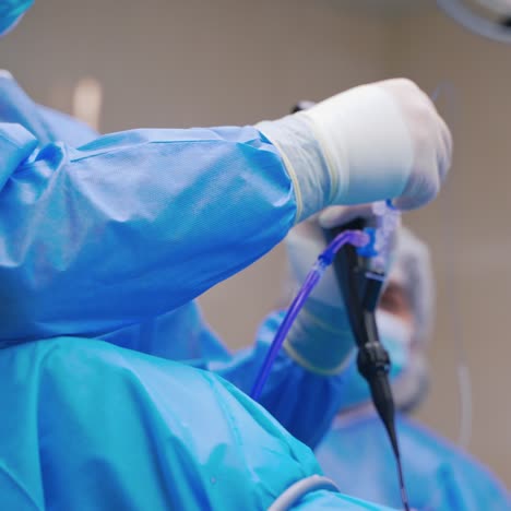group of doctors perform an operation to a patient. surgeons in medical uniform and masks working in the operating room.