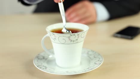 Businessman-Drinking-Coffee-At-Office