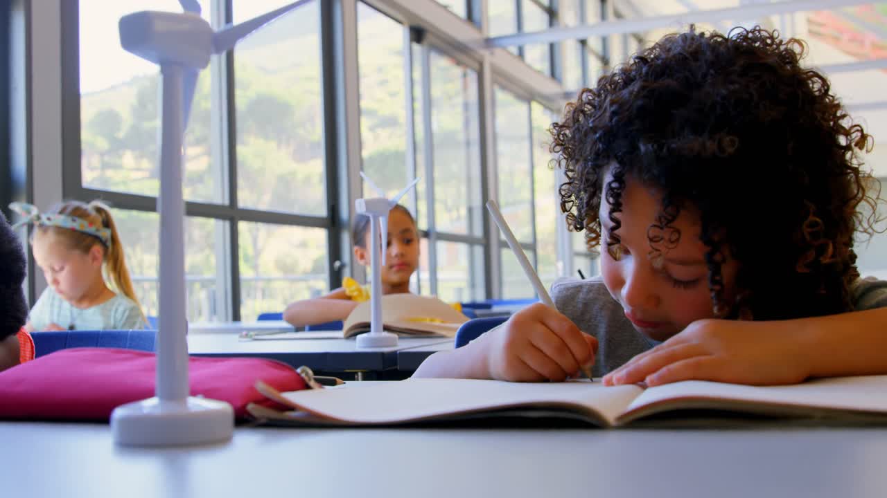 Schoolboy studying at desk in classroom 4k
