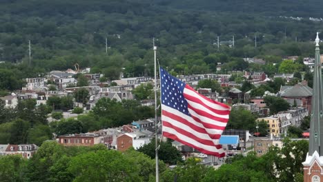 Amerikanische-Flagge-Weht-über-Nachbarschaft-Und-Kirche-In-Der-Stadt-Der-USA