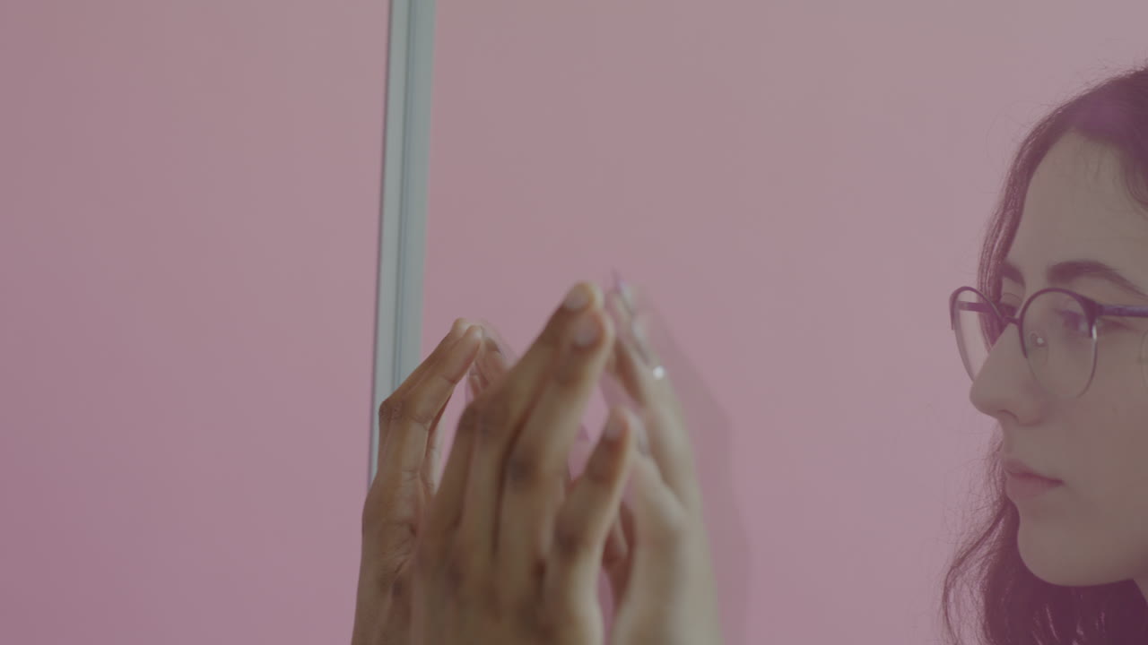 Two People Interacting in Front of a Pink Wall