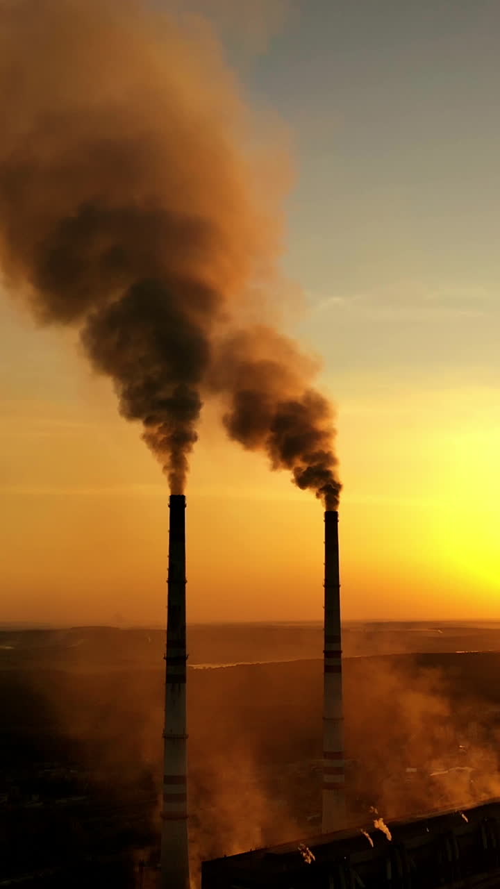 Steam on chimney of power plant. Air pollution from power plant chimneys Vertical video