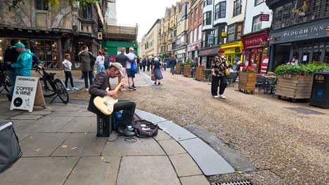 guitarist playing on busy oxford street