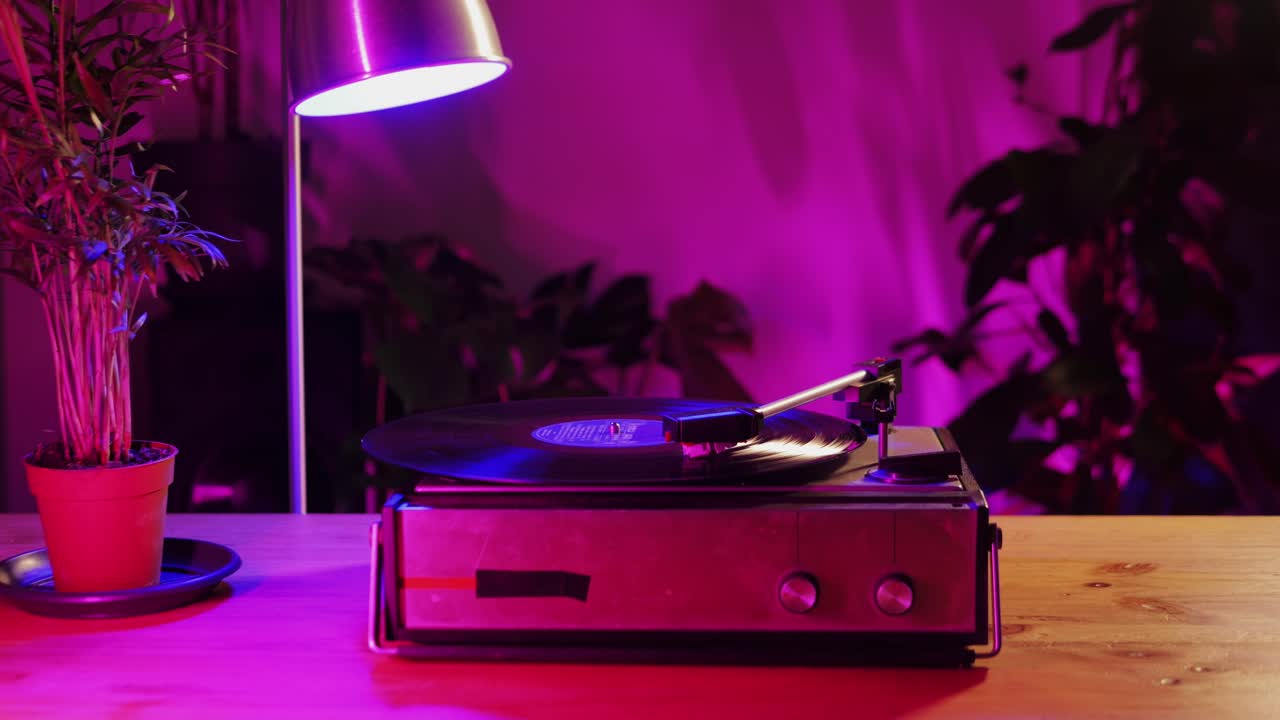 Retro Vinyl record player playing music, close-up macro shot of vintage LP disc old phonograph spinning. Retro music player.