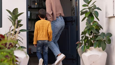 mother greet child at door of home enjoying new