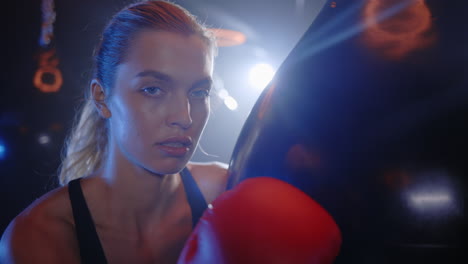 woman boxer training with punching bag