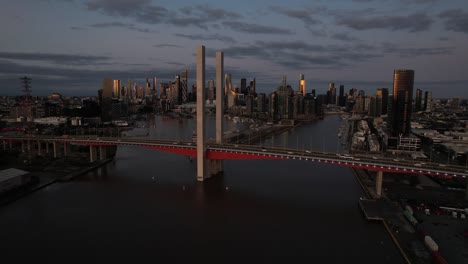 aerial car crossing bolte bridge melbourne city skyline dusk, australia