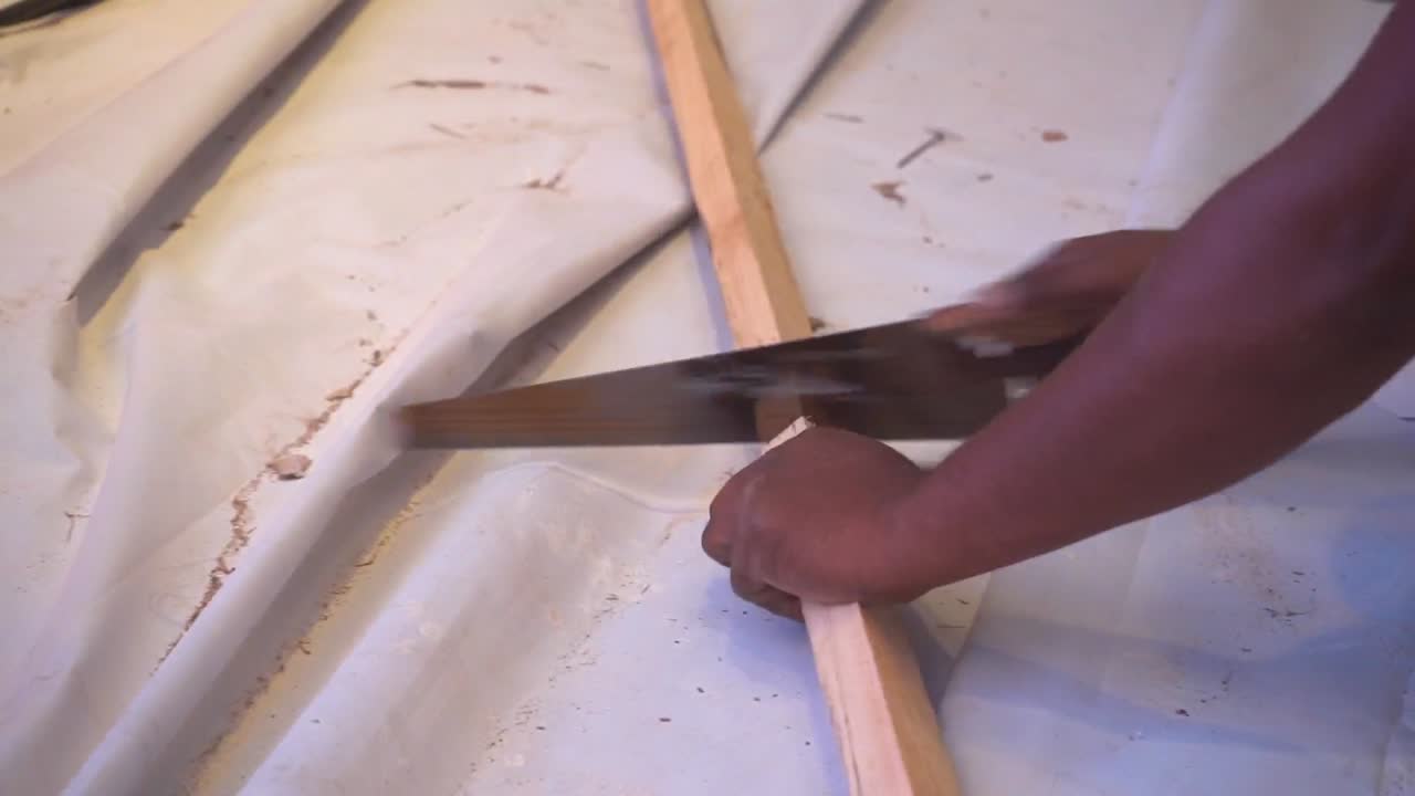 a carpenter  cuting the wood  closeup view