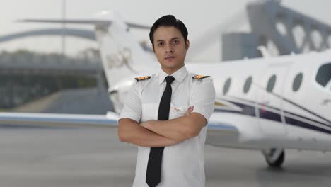 Portrait-of-Indian-male-pilot-standing-crossed-hands