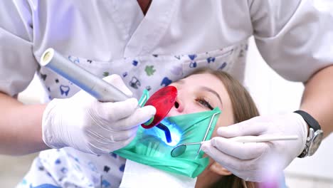 dentist at work in the office. dentist performing surgery using sterilised equipment