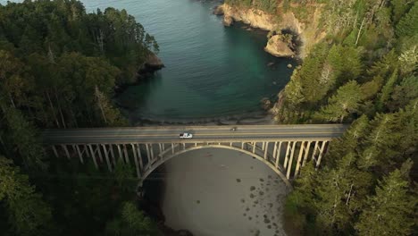 lowering overhead aerial view of an arched overpass bridge in california