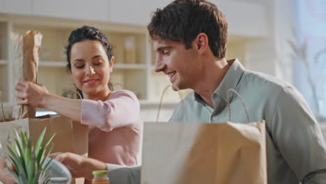 couple unpacking delivered products at kitchen together closeup. online services