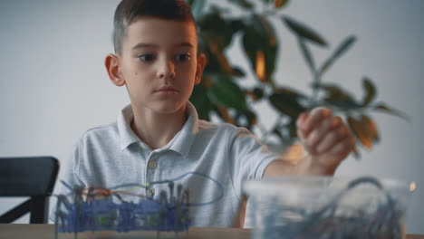 little boy building a robot