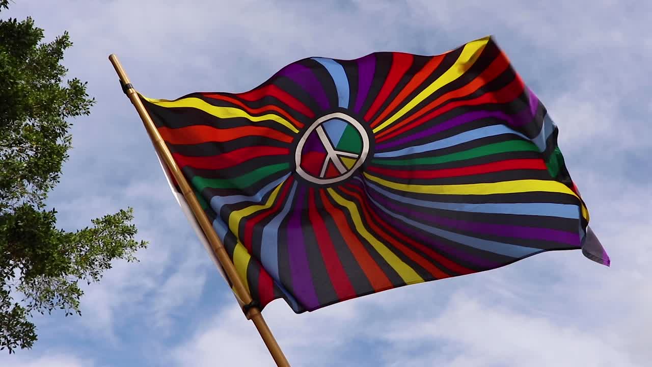 bandera colorida con un signo de paz blanco que sopla lentamente en el viento