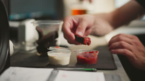 person eating jerky with sauces