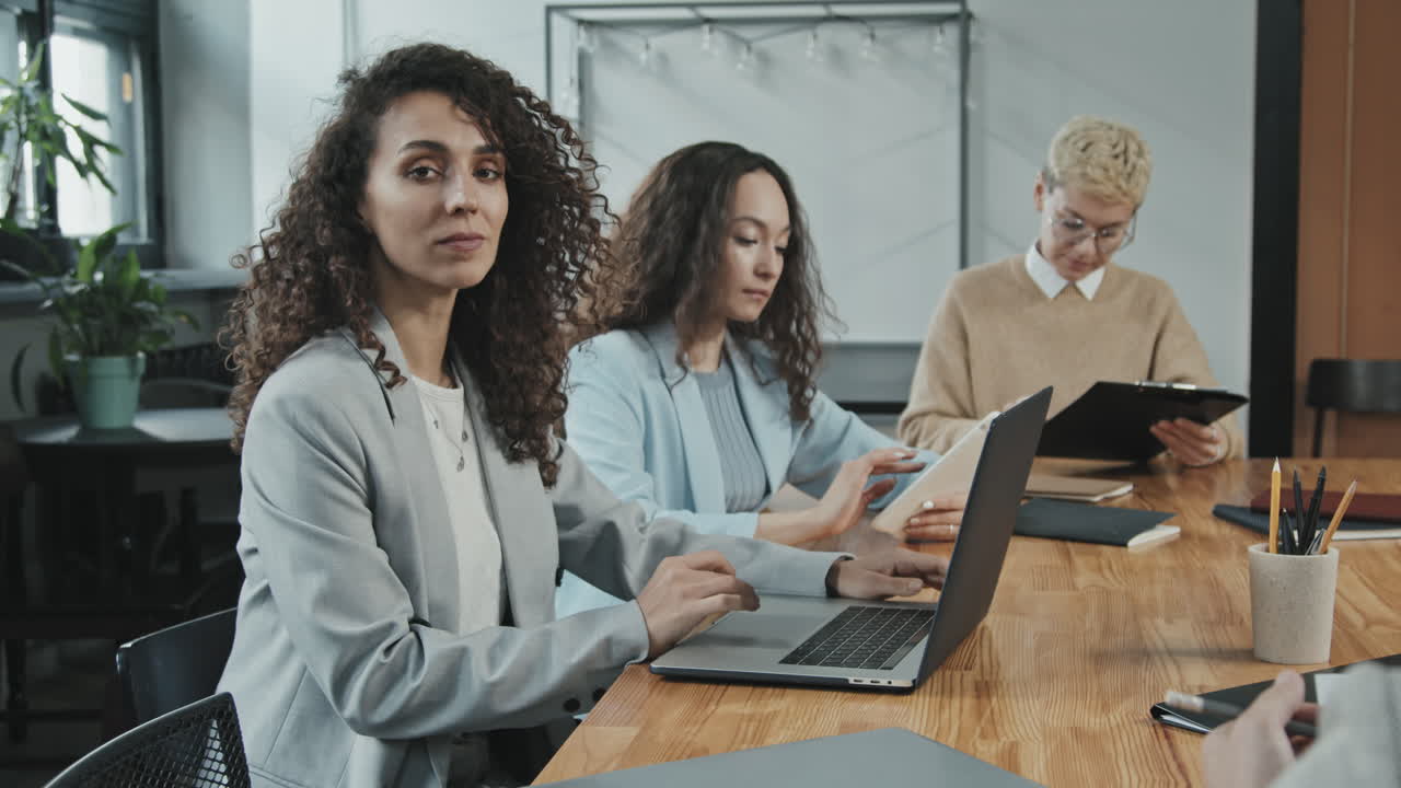 Serious Female Investor Working on Laptop