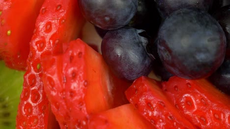 Macro-rotating-shot-of-succulent-blueberries-and-detailed-strawberries