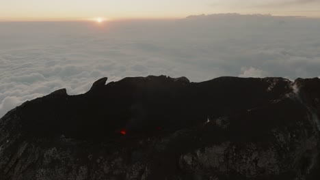 flying near the crater of fuego volcano during sunrise next to acatenango volcano in guatemala